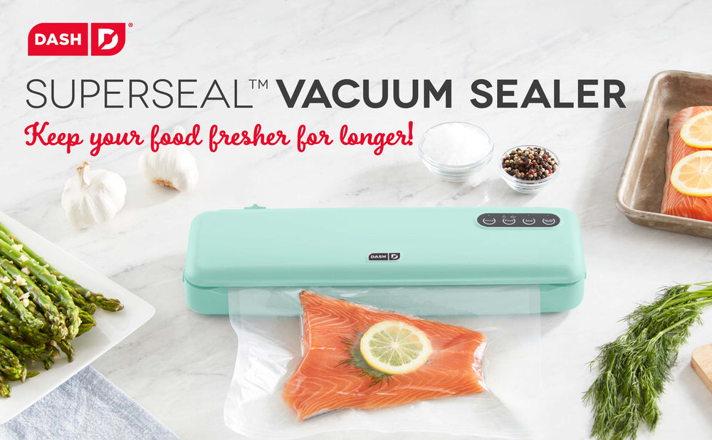 An aqua colored vacuum sealer sealing salmon with a slice of lemon.