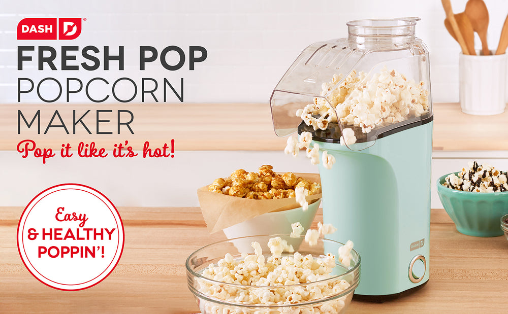 A blue Fresh Pop Popcorn Maker pops corn into a glass bowl.
