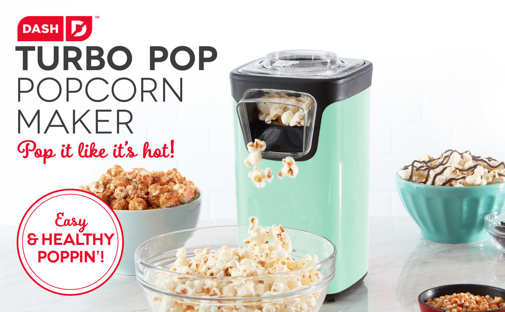 An aqua popcorn maker pops fresh popcorn into a glass bowl.