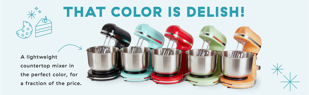 5 Delish by Dash Stand Mixers lined up in blue, black, red, green, and orange.
