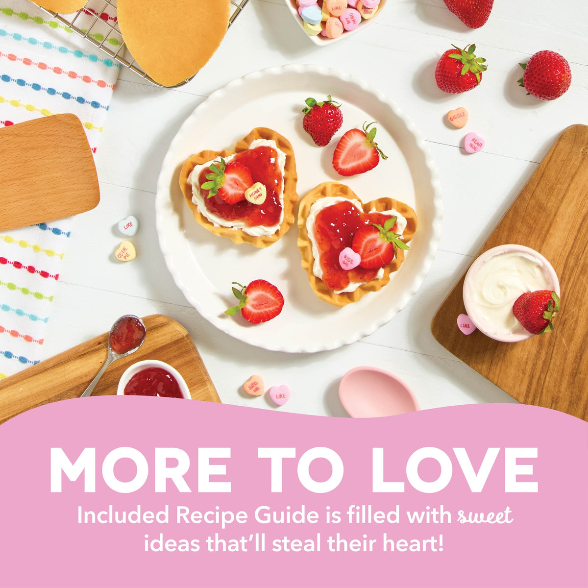Heart-shaped waffles topped with strawberries, whipped cream, and candy hearts on a white plate—Valentine’s-inspired breakfast idea from the included Recipe Guide.