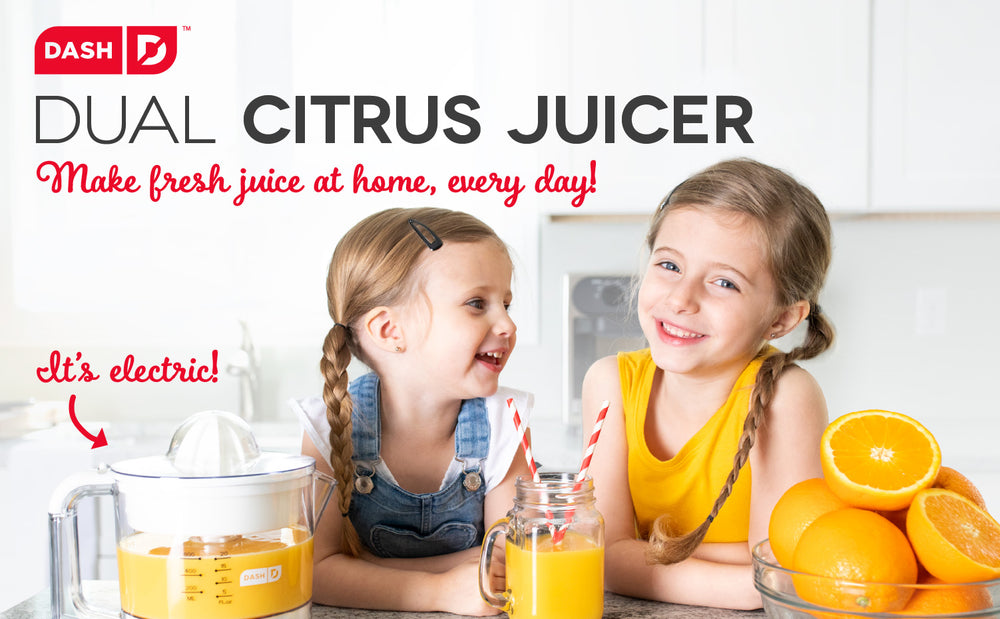 2 joyful young girls share a freshly squeezed orange juice with 2 striped straws.