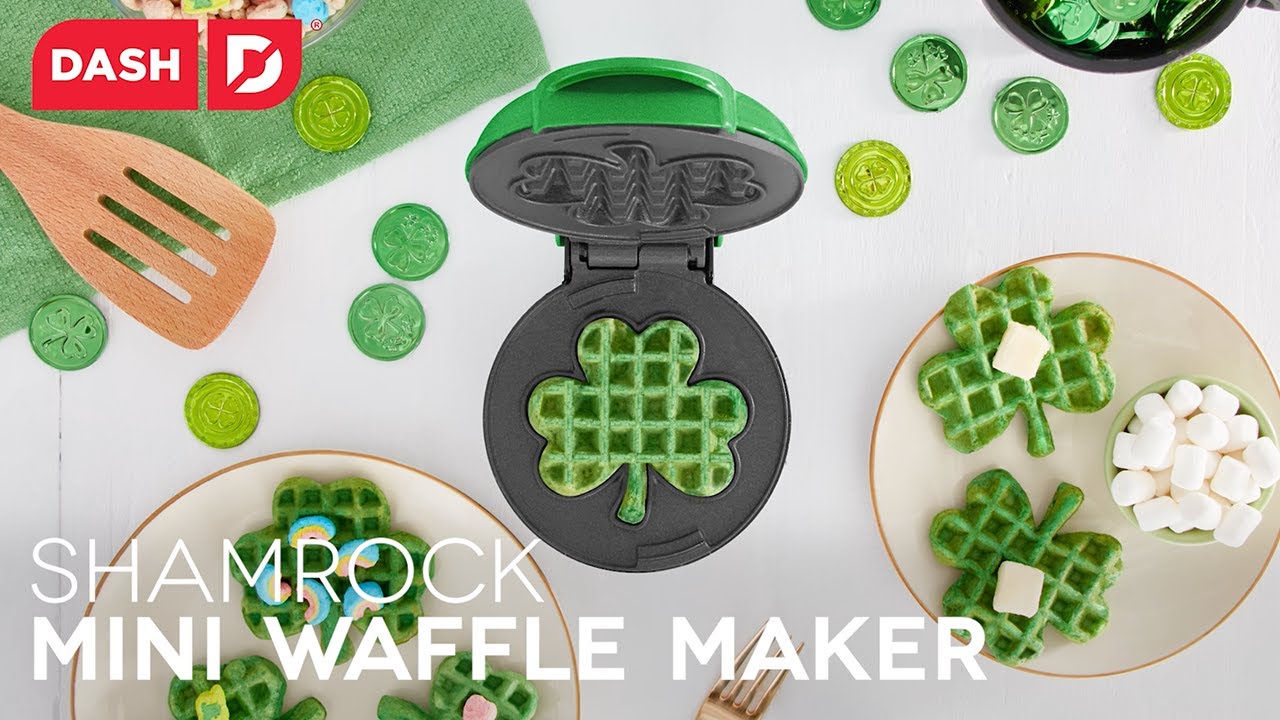 Waffle batter is added to the maker and cooked to make shamrock-shaped mini waffles.