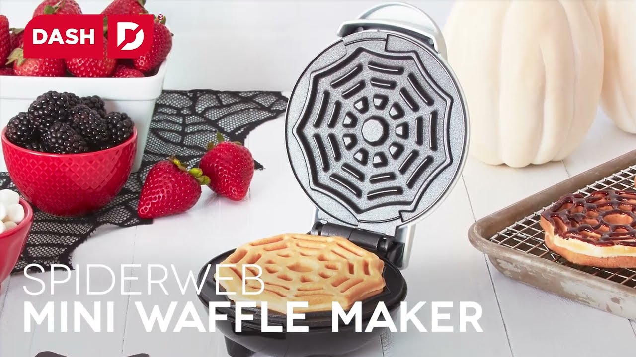 A four inch mini waffle with a spider web print is shown in the mini waffle maker.