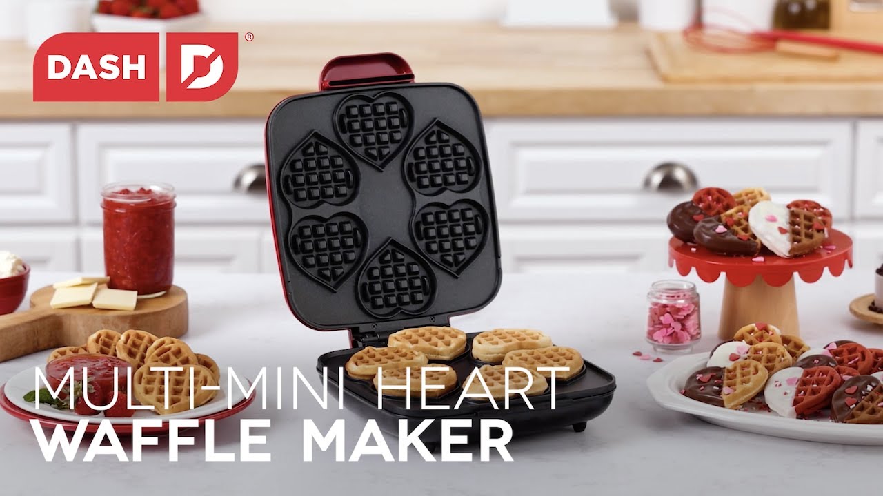 Waffle batter is added to the maker and cooked to make six mini heart-shaped waffles. The mini heart-shaped waffles are dipped in chocolate and decorated with sprinkles.