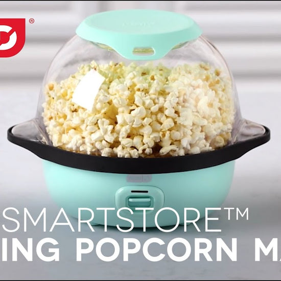 Video demonstrating that making popcorn at home is so POPPING easy with the Dash SmartStore™ Stirring Popcorn Maker. Step 1: Use the included kernel measuring cup lid. Step 2: Assemble and turn on the popcorn maker. Step 3: Add butter to the built in melting tray. Make 12 cups of popcorn in minutes, and when it’s ready just flip over and enjoy. SmartStore™ design makes it so the lid and base stack together, taking up less space in your cabinets.
