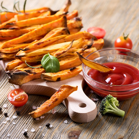 Crispy sweet potato fries with a side of ketchup.