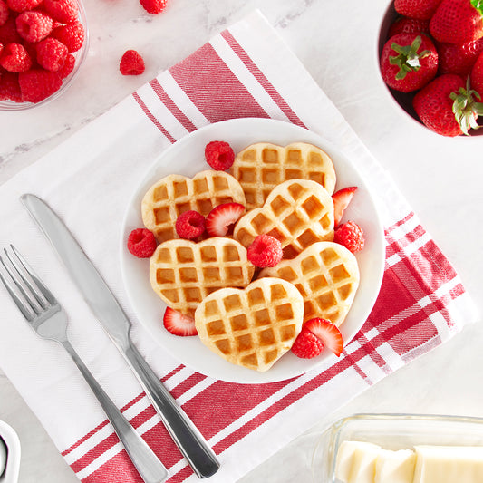 Plate of 3 mini heart shaped waffles made with a Rise by Dash Heart Mini Waffle Maker.