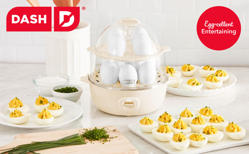 Dash egg cooker with deviled eggs on a table, featuring the Dash brand.