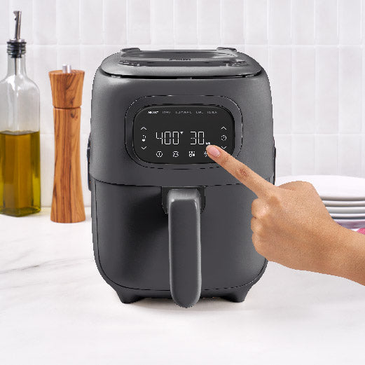 Person adjusting settings on a 3QT Flip & Fry™ Digital 2-in-1 Grill + Air Fryer Air Fryer Dash Forged Iron