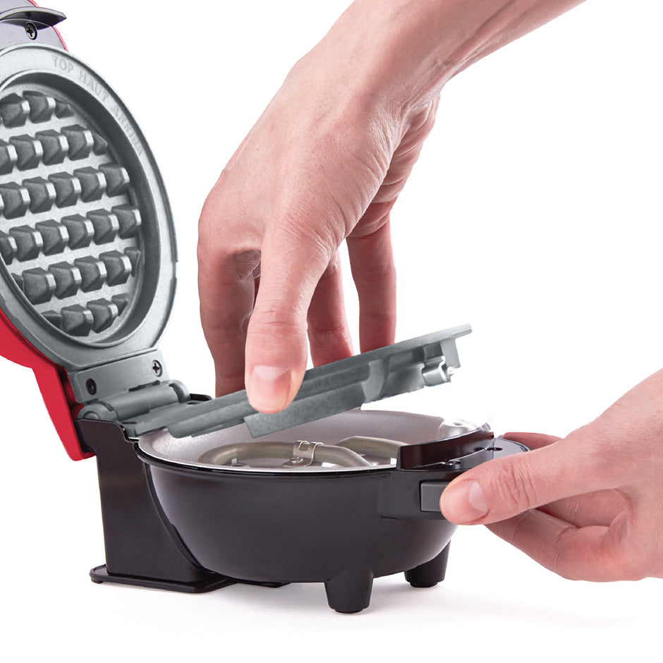 Close-up of Dash | Disney MultiMaker™ Mini System with removable plate being swapped out for easy cleaning and customization.
