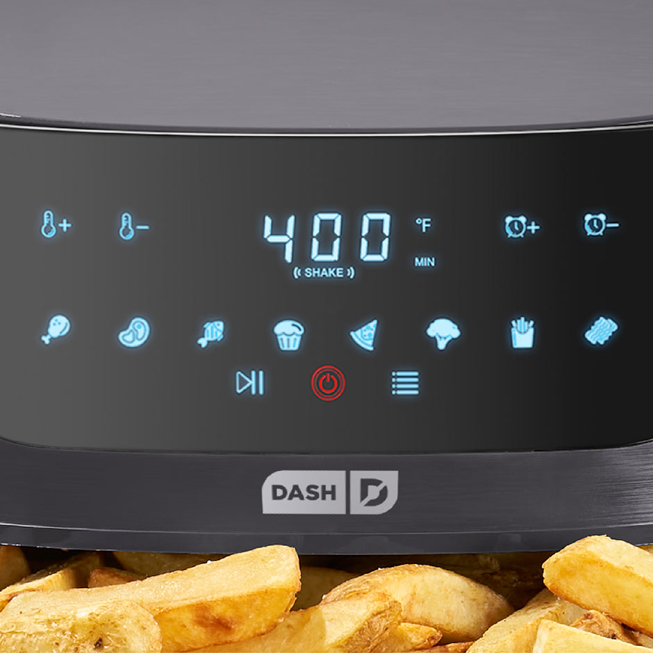 Digital display of an air fryer with food items in the foreground