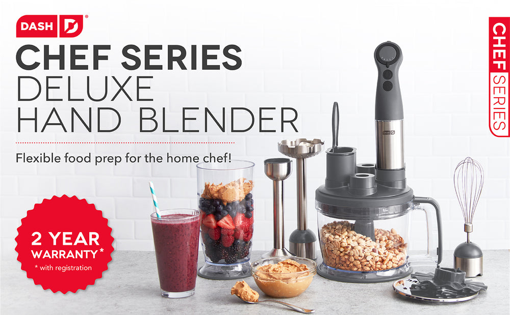 A Chef Series Deluxe Hand Blender on a counter full of nuts for creating nut butter to eat by itself or in a berry smoothie.