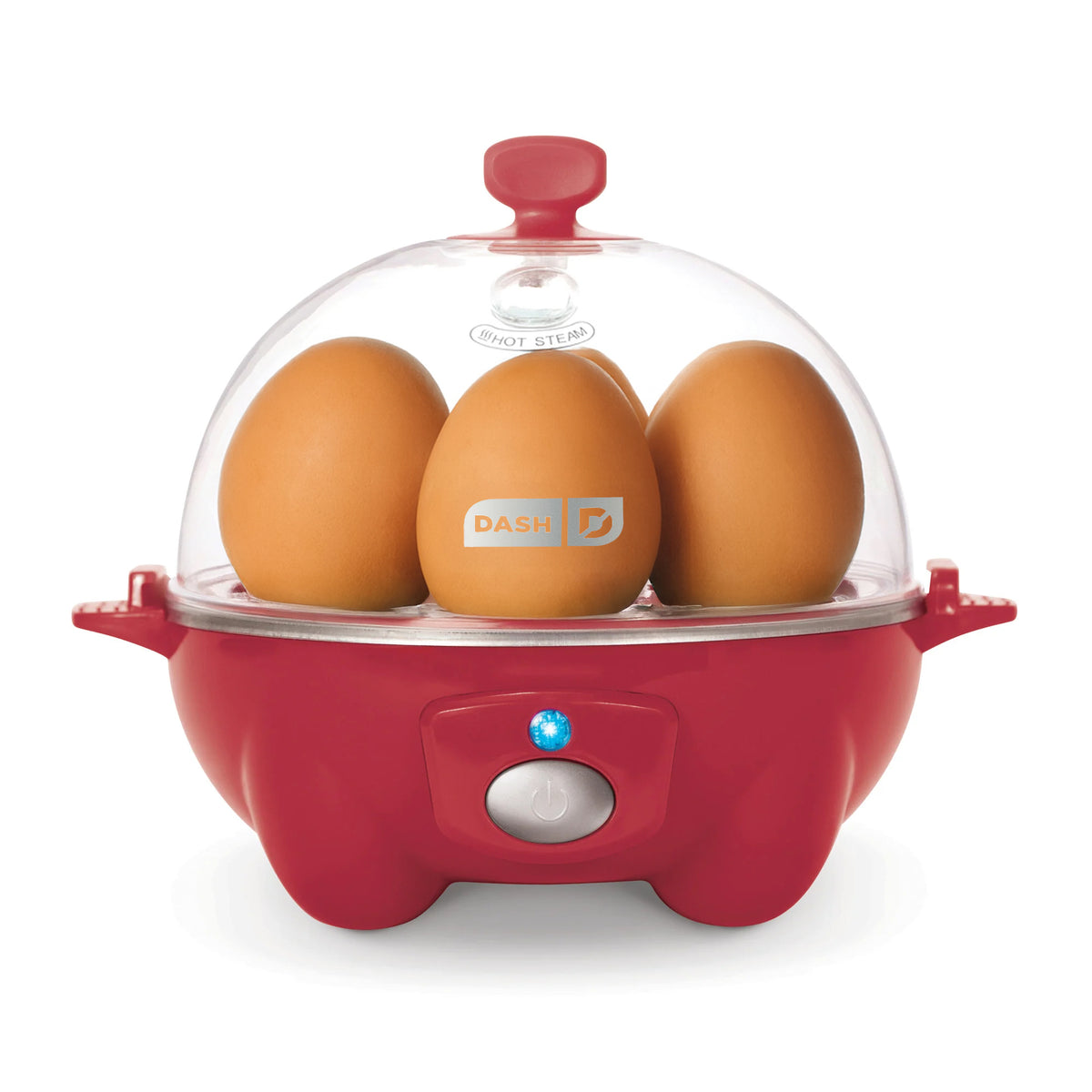 Red egg cooker with clear dome lid holding three brown eggs and power button on front.