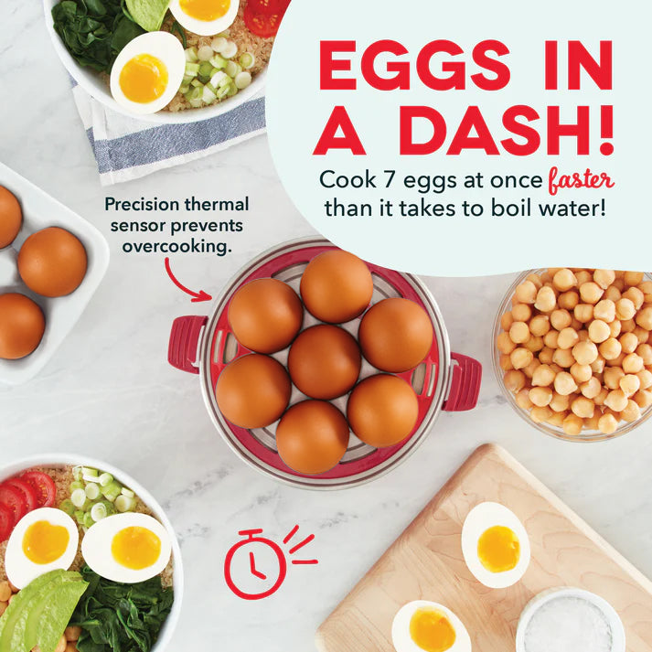 Red and clear egg cooker basket filled with brown eggs, surrounded by cooked eggs in bowls and on plates with vegetables.
