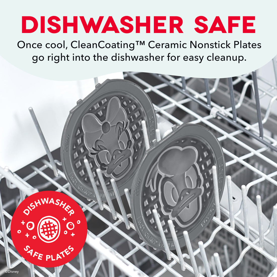 Two gray nonstick waffle plates with character designs inside a dishwasher rack.