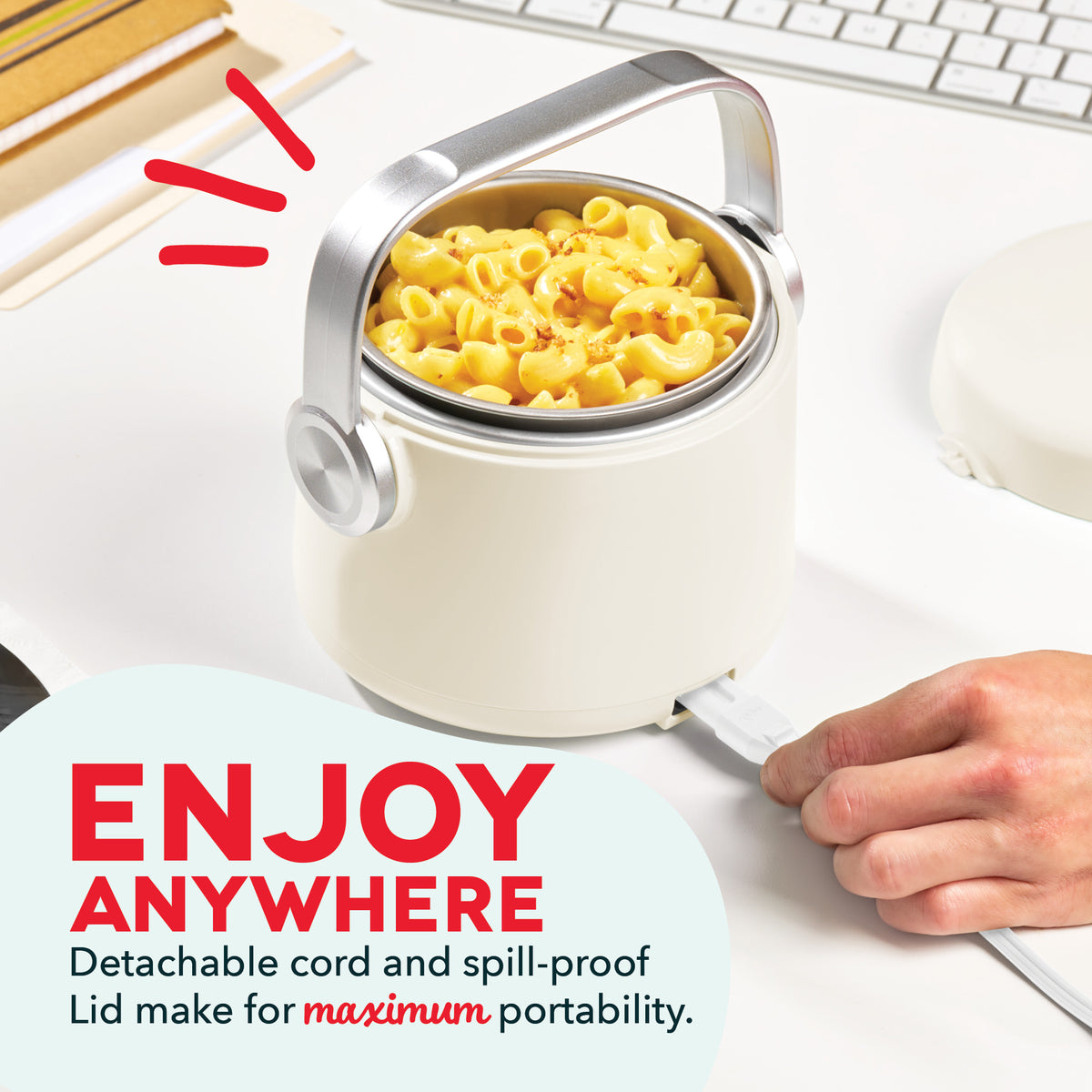 White electric lunchbox with silver trim containing mac and cheese, featuring detachable cord and handle.