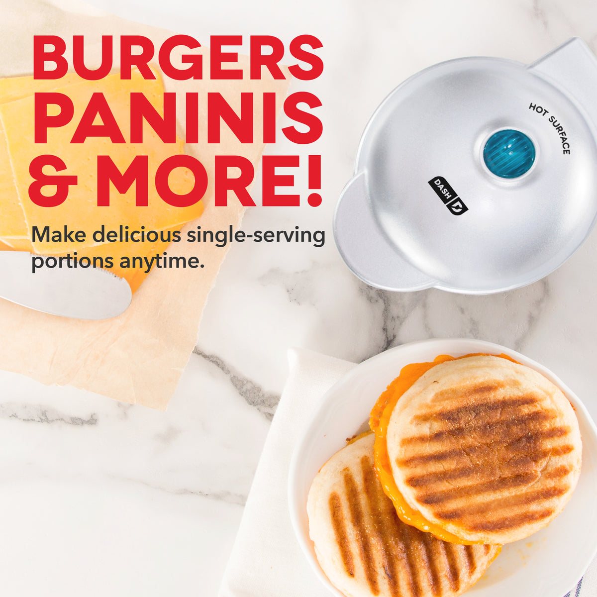 White round grill with blue dial and hot surface indicator, shown with grilled cheese sandwich on plate.