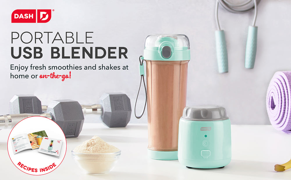 An aqua colored blender full of smoothie next to weights and workout equipment.
