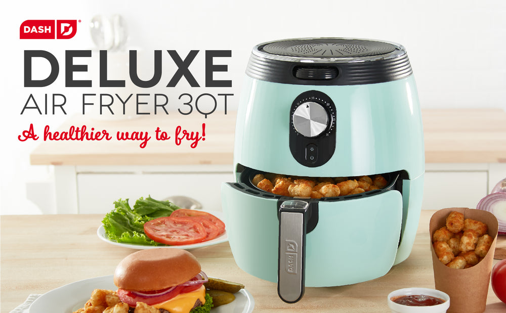 A 3 quart blue Deluxe Air Fryer sits ajar with air fried chicken in the drawer alongside a burger, tater tots, and toppings. 