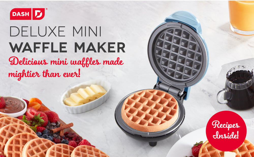 A spread of waffles made with the Deluxe Mini Waffle Maker with berries, butter, syrup, and juice. 