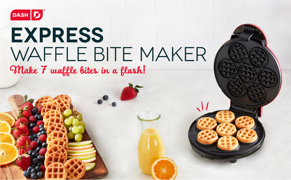 The Express Waffle Bite Maker sits open with 7 fresh waffle bites next to a wooden board of bites, berries, and citrus.