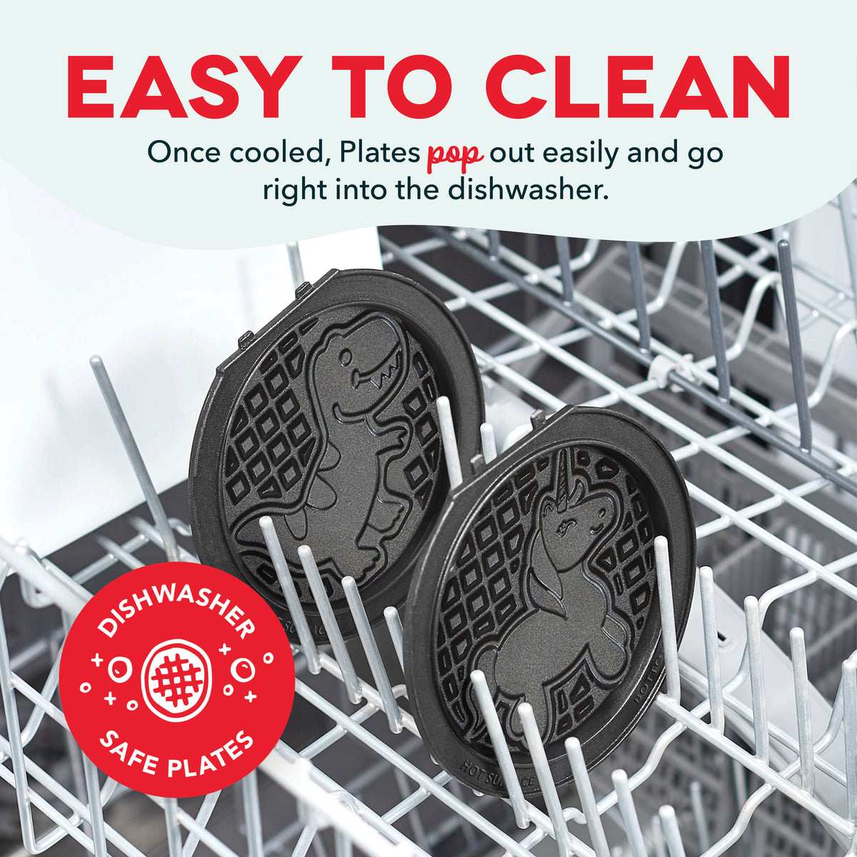 Two dark removable waffle and griddle plates with handles in dishwasher rack.
