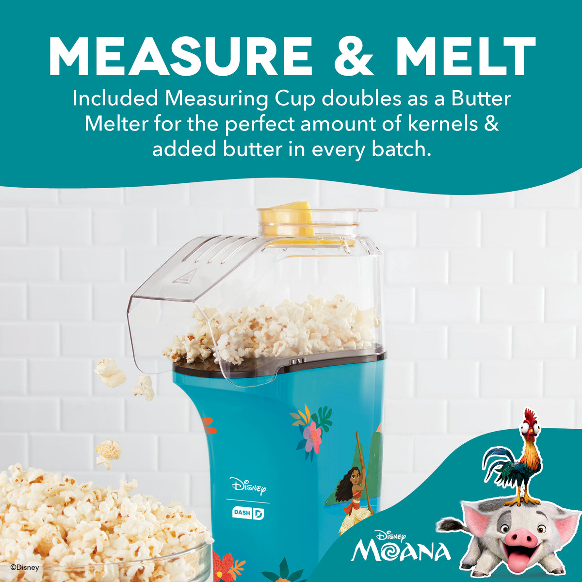 Turquoise popcorn maker with clear top chamber filled with popcorn, yellow measuring cup on top, and Disney Moana characters 