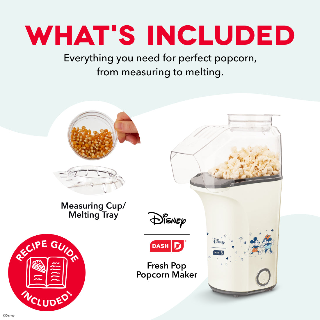 Cream-colored popcorn maker with Disney characters, measuring cup with kernels, melting tray, and recipe guide included.