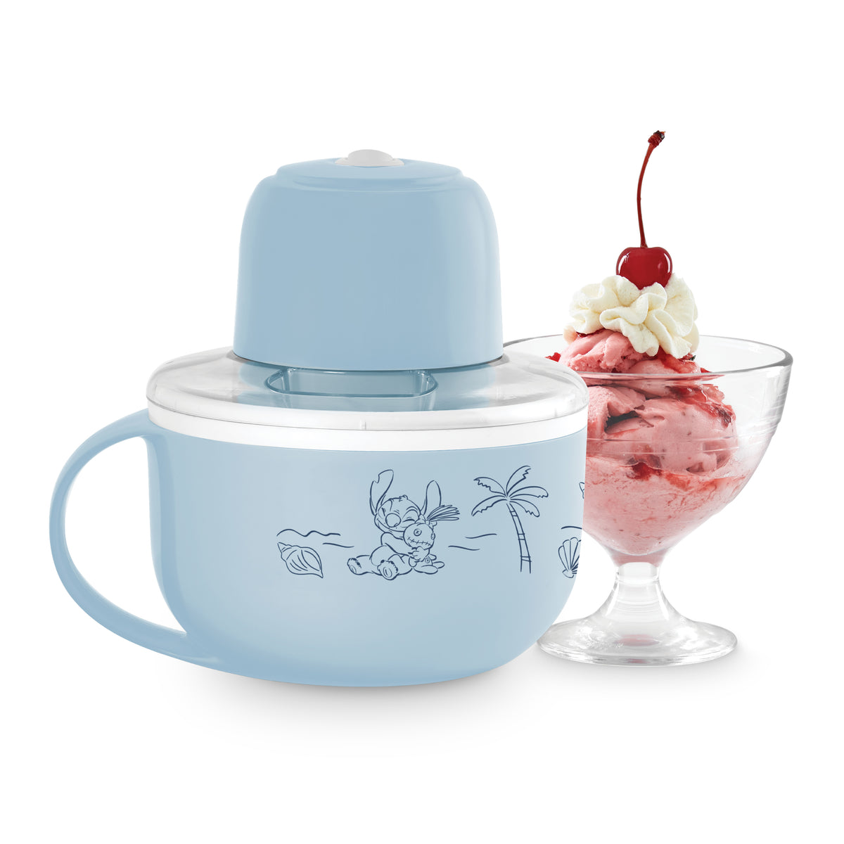 Blue mug-style ice cream maker with illustrated design and serving glass containing strawberry ice cream topped with whipped 