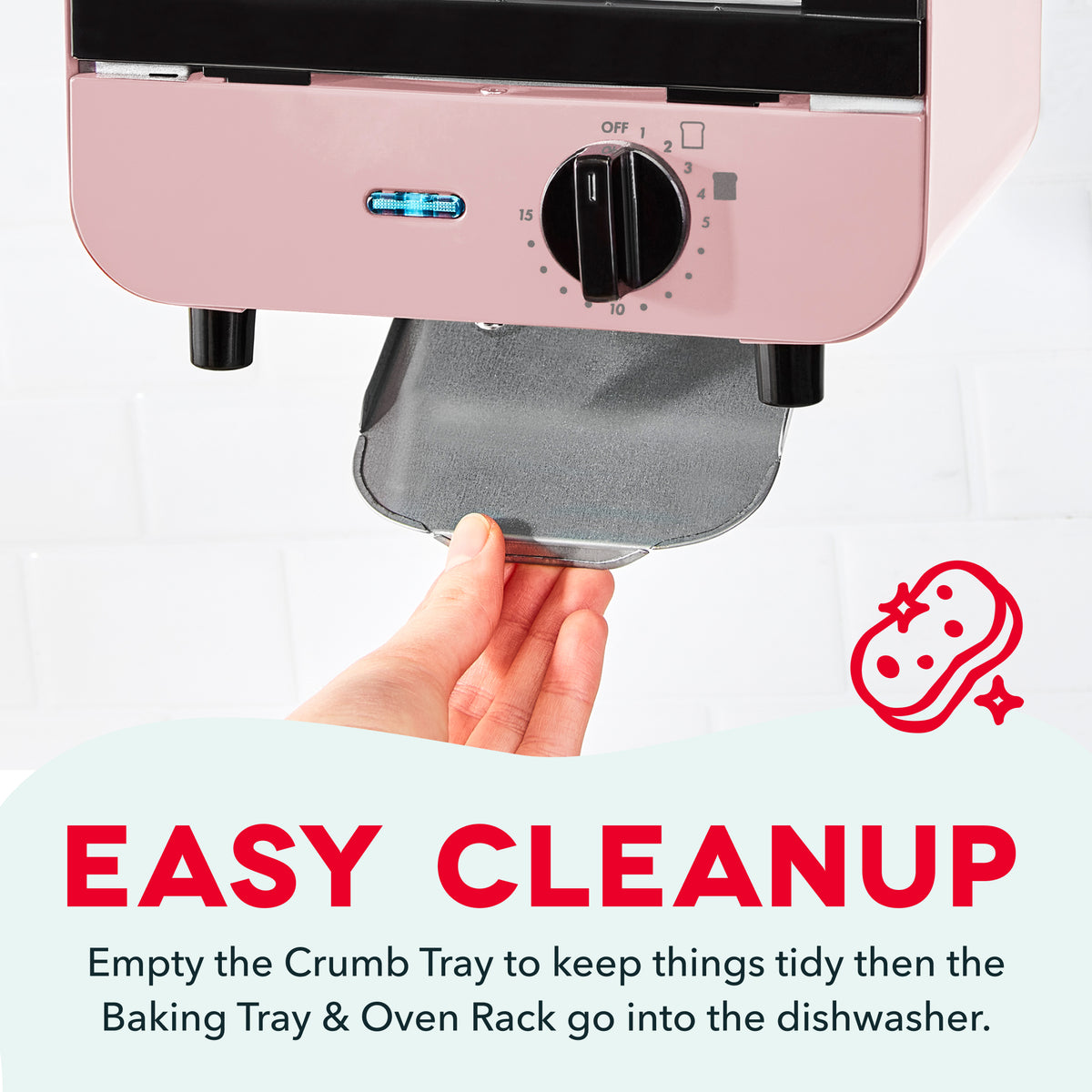Pink mini toaster oven with black knob and digital display, crumb tray being pulled out by a hand.