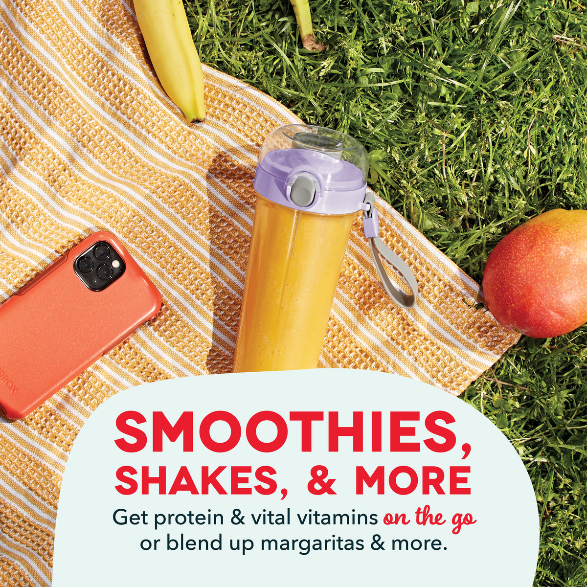 Yellow portable blender with purple lid on striped blanket surrounded by banana, apple, and phone.