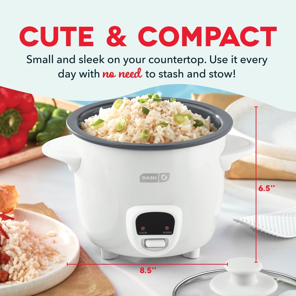 White mini rice cooker with dark gray lid containing cooked rice with green onions, measuring 8.5" wide by 6.5" tall.