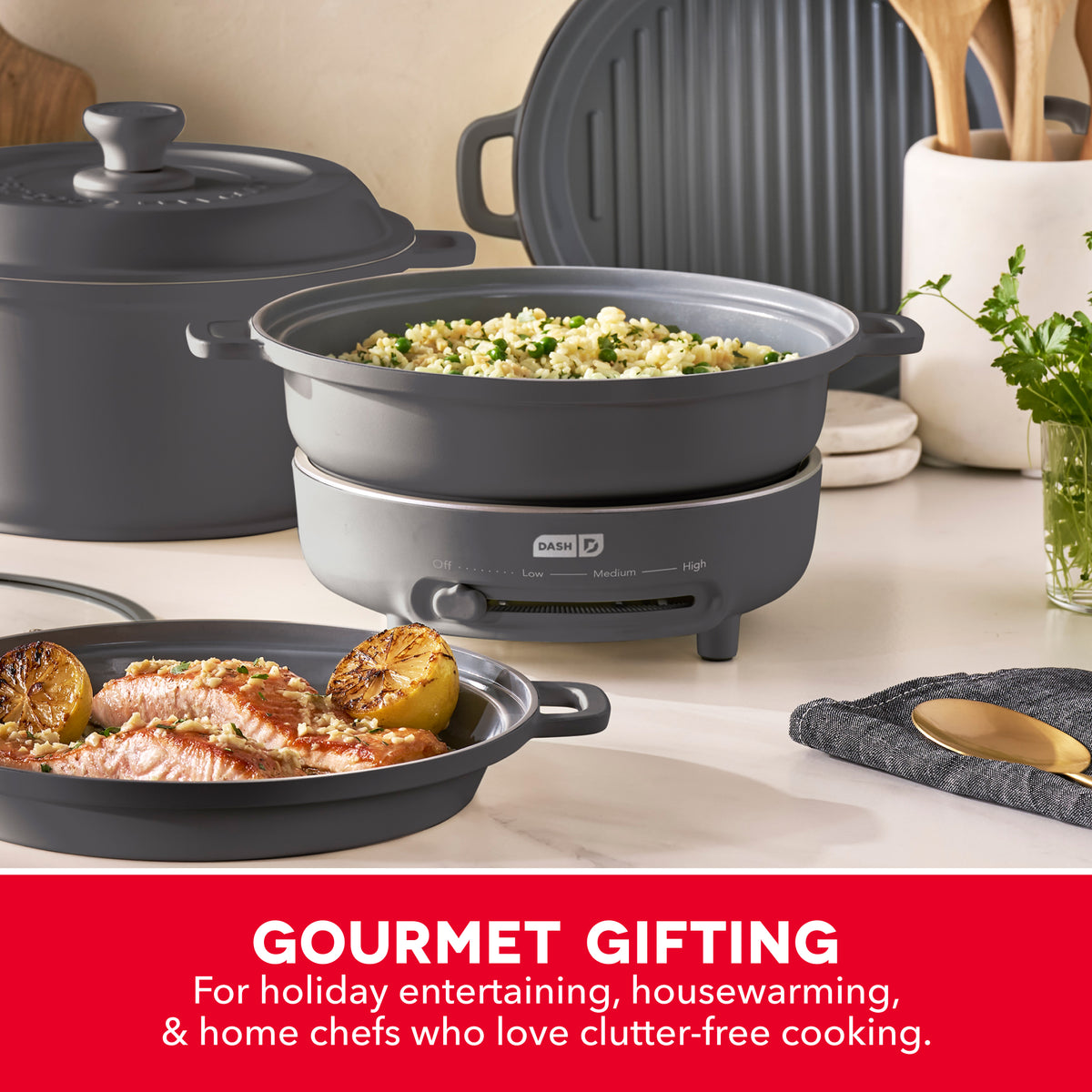 Ceramic cookware set with electric burner, including black covered pot, skillet with cooked salmon and potatoes, and grill pa