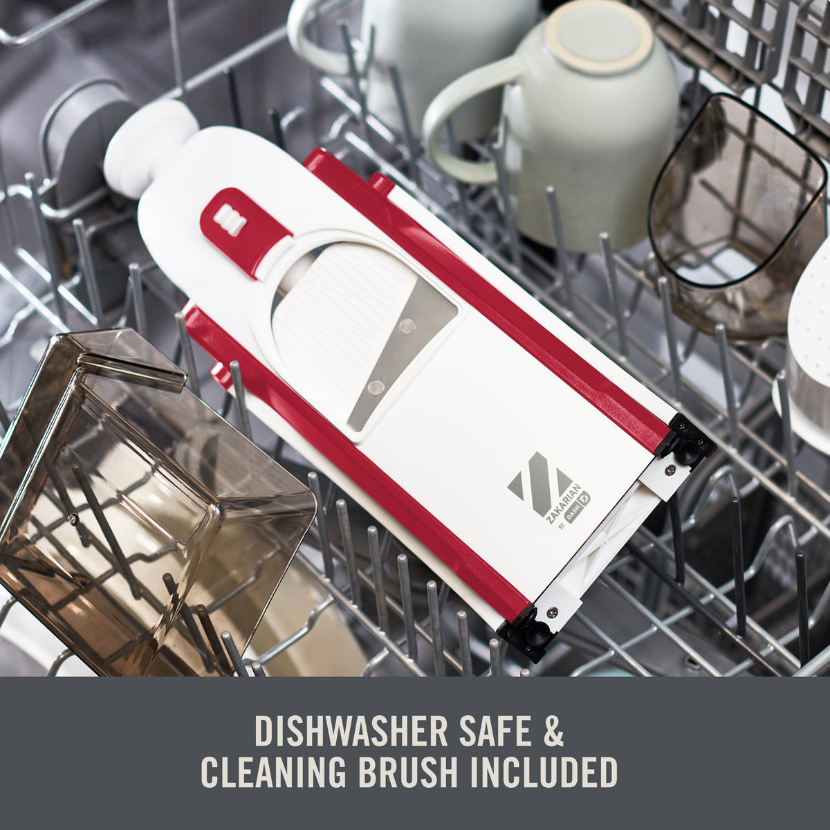White and red mandoline slicer with blade guard inside dishwasher rack alongside cleaning brush and other items.
