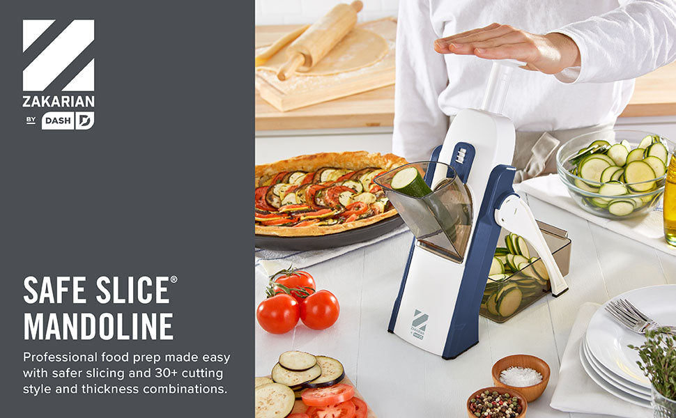 Zakarian by Dash Safe Slice® Mandoline in navy and white shown slicing zucchini with hands-free design for safer food prep, featuring 30+ slice settings for precise, uniform cuts—perfect for creating professional meals like vegetable tarts and salads.