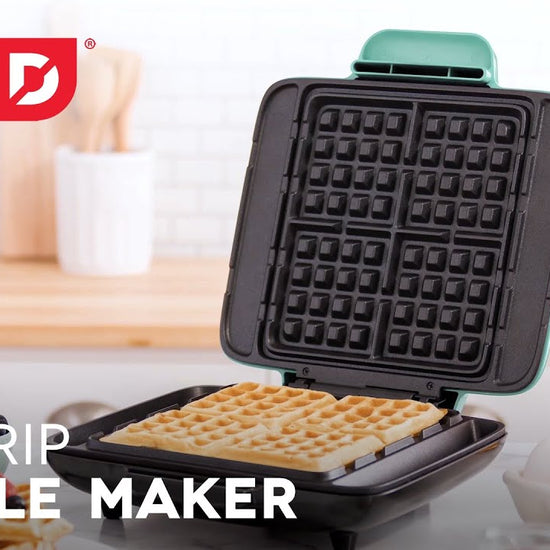 Waffle batter is added to the maker and cooked to make four square mini waffles and two waffle sticks.
