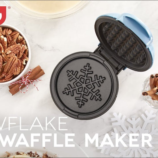 A four inch mini waffle with a snowflake print is shown in the mini waffle maker.