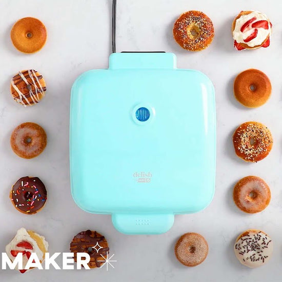 Donut batter is piped into the donut maker, donuts are removed and decorated with various toppings.